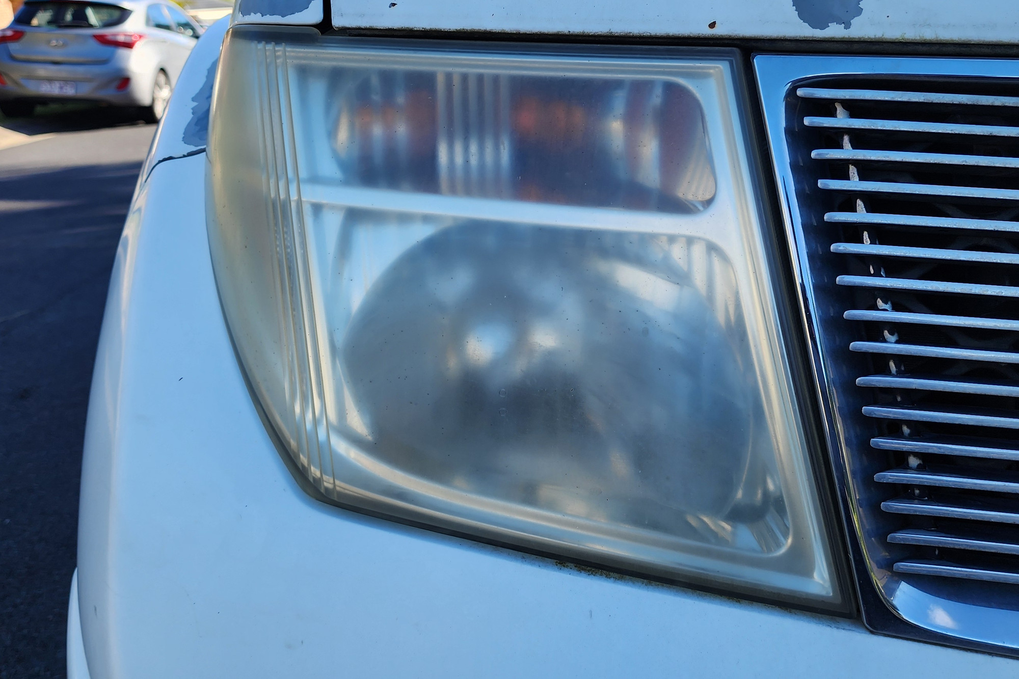 Hazy, yellowed headlight lens before restoration